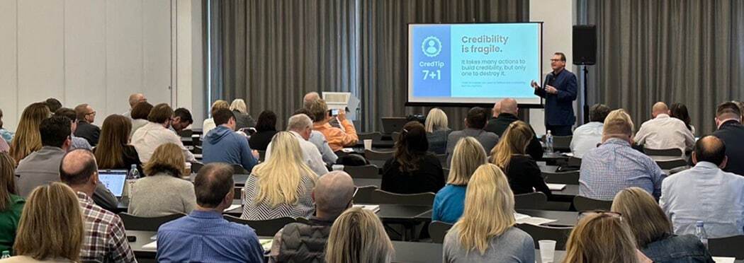 speaker presenting to an audience during a conference