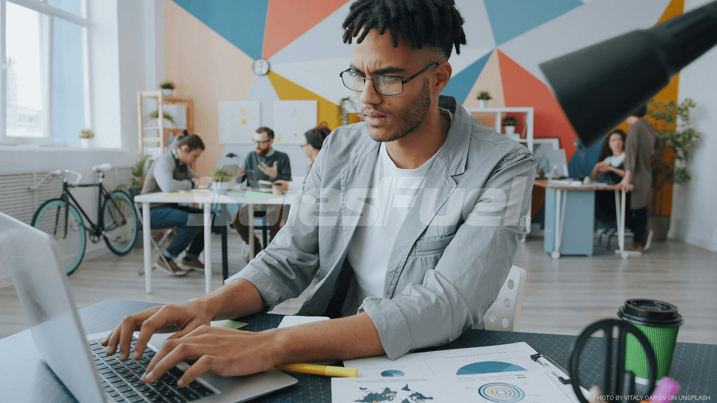 man with glasses at computer
