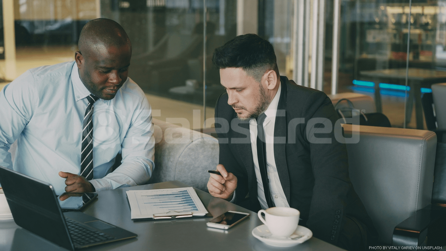 two men sitting at table