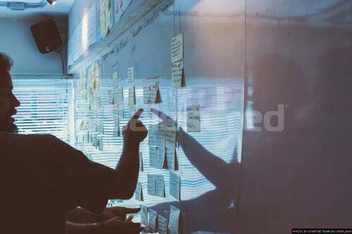 man looking at whiteboard